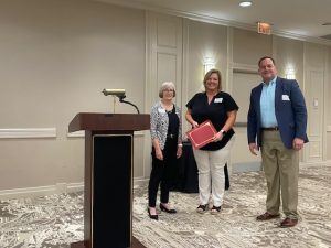 Amy Haines and Chris D’Esposito accept the Partnership Award from Cathy Andreen on behalf of the Department of Parking Services.